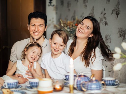 loving family laughing at table having cozy meal